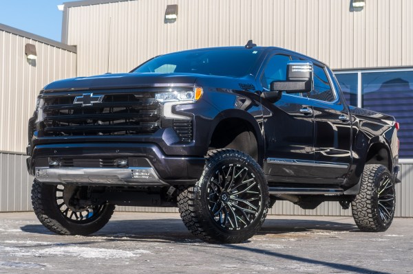 2024 Chevrolet Silverado 1500 High Country with a 6" Rough Country lift kit, 22x12 TIS 566BM wheels, and 35" Fury Country Hunter R/T tires.
