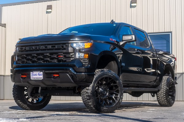 2024 Chevrolet Silverado 1500 Custom Trail Boss with a 6" Rough Country lift kit, 22x12 Fuel Twitch wheels, and 35" Fury Country Hunter R/T tires.