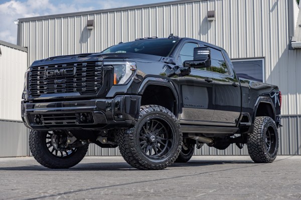 2024 GMC Sierra 2500 Denali with a 5" BDS lift kit, 22x12 TIS 547B wheels, and 37" Nitto Ridge Grappler tires.