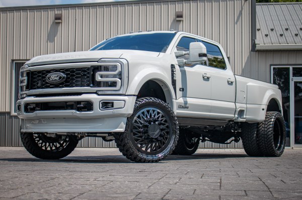 2025 Ford F-450 Super Duty Platinum with a 4" Wicked lift kit, 26x8.25 KG1 Forged Glaze wheels, and 37" AMP Terrain Attack M/T A tires.
